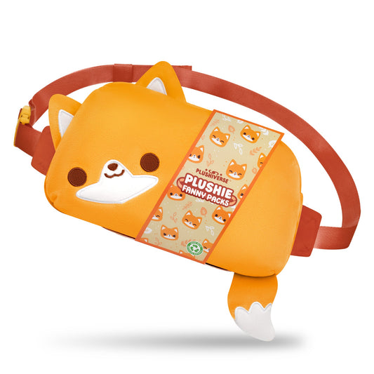 Orange fanny pack featuring a fox design with ears and a tail. Part of the Kawaii Cuties collection, it boasts a smiling face, white accents, and an orange adjustable belt. This TeeTurtle Plushiverse Feeling Foxy Plushie Fanny Pack offers hands-free functionality with style. Packaging displays